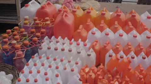 Plastic white and orange cans to selling in the market for bring Ganga water Stock Footage 221889360