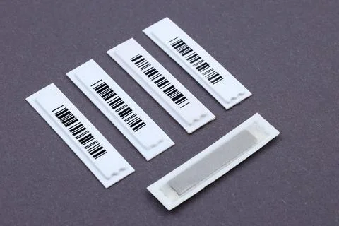 Plastic White Barcode Soft Tags on gray Stock-Fotos