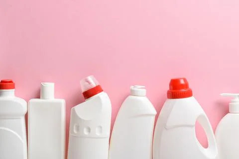 Plastic white bottles lie on a light pink background. Layout of bottles with  Stock Photos