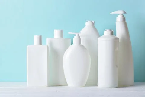 Plastic white bottles on a light blue background. Layout of bottles with Stock Photos