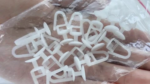 Plastic White Curtain Hooks In Zip Bag In Female Hand Close-Up Stock Footage 318130094