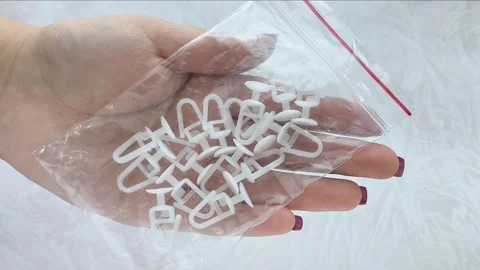 Plastic White Curtain Hooks In Zip Bag In Female Hand Close-Up Video stock 318130145
