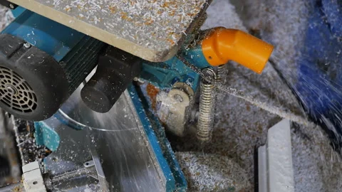 Plastic white filings fly out of a circular electric saw in the process of cutti Stock Footage 234633070