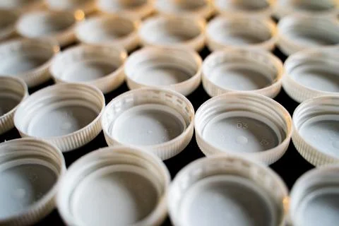 Plastic white trash caps Foto stock