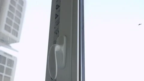 Plastic window frame features protective tape and handle Vídeos de archivo 332717751