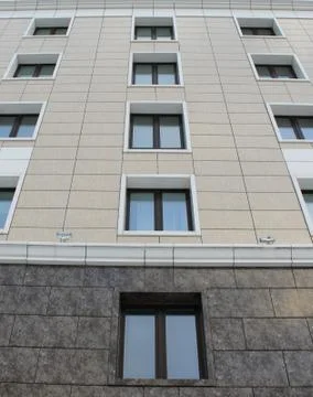 Plastic windows in a modern tiled brick high-rise house. Stock Photos