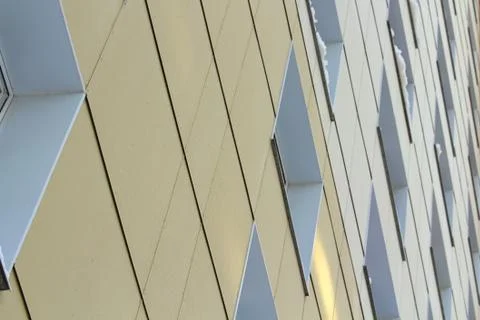Plastic windows in a modern tiled brick high-rise house. Stock Photos