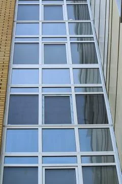 Plastic windows in a modern tiled brick high-rise house. Stock Photos