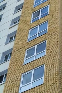 Plastic windows in a modern tiled brick high-rise house. Foto stock