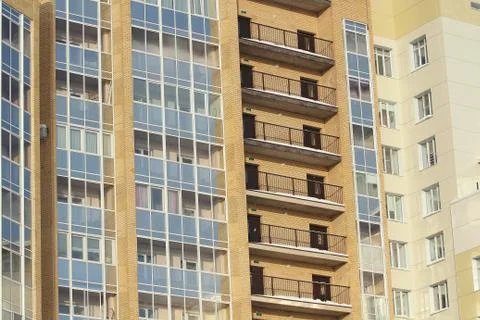Plastic windows in a modern tiled brick high-rise house. Stock Photos