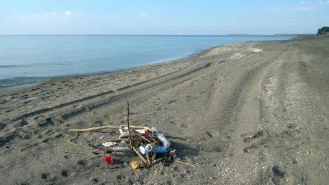 Plastic wooden debris polluting sandy ocean beach shore. Stock Footage 309197111