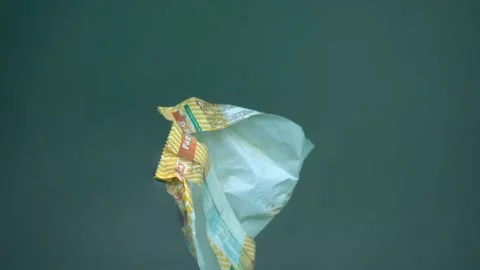 Plastic wrapper bag floating in the ocean Stock Footage 177911676