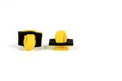 Plastic yellow clips for cars. Close up. Isolated on white background Stock Photos