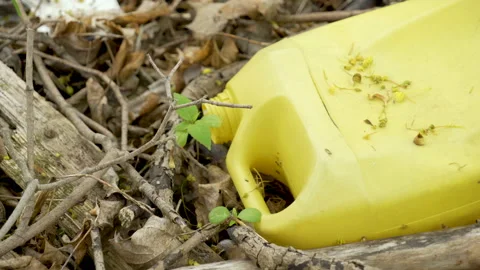 A plastic yellow oil container of the grass Stock Footage 137359204