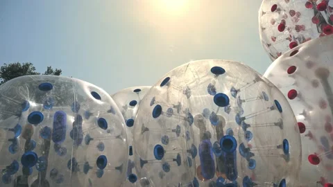 Plastic zorbing ball. close-up. rolling zorbs. Zorbing Balls on a Playground Stock Footage 166110135
