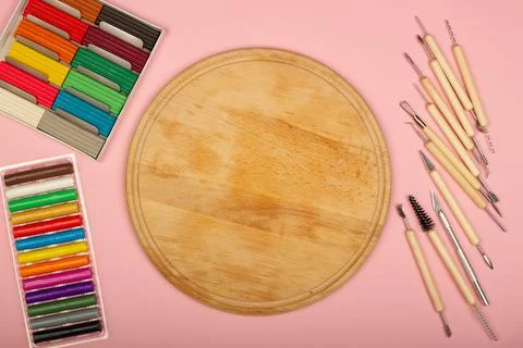 Plasticine modeling tools kit on a pink background. Wooden desk in the classroom Stock Photos
