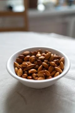 Plate with almonds on a light surface Stock Photos