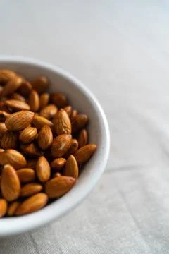 Plate with almonds on a light surface Stock Photos