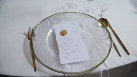 Plate and menu on the table. Table cutlery empty glasses waiting for guest Stock Footage 235470673