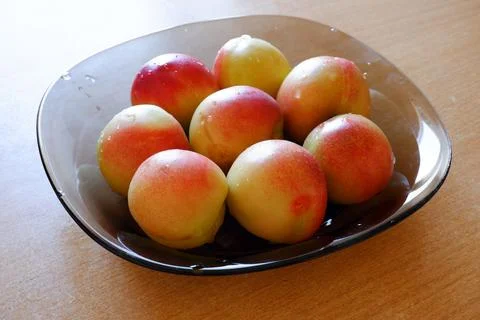 Plate with apricots on the dining table Stock Photos