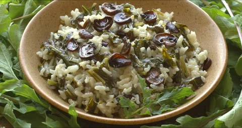 A plate of arugula risotto with champignons. Stock Footage 311340248