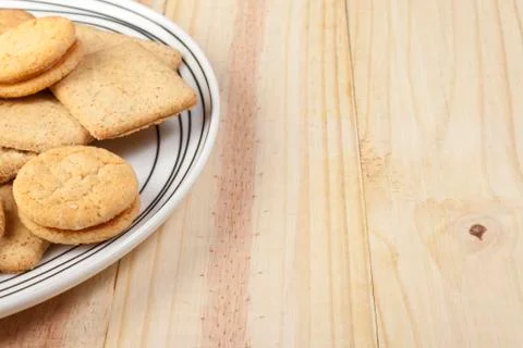 Plate of assorted biscuits on a pine country table Stock Photos
