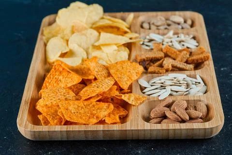 Plate of assorted snacks on a dark background Stock Photos