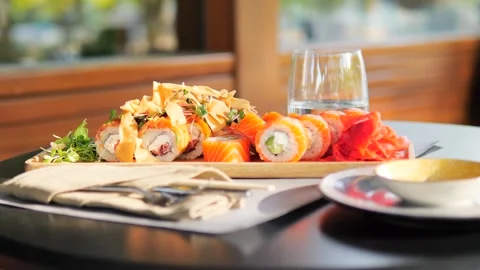 Plate of assorted sushi rolls elegantly displayed on restaurant table Stock Footage 282717740