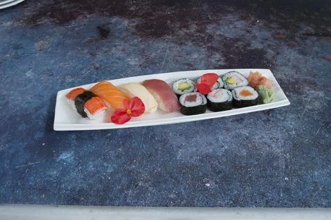 A plate of assorted sushi is on a table Stock Photos