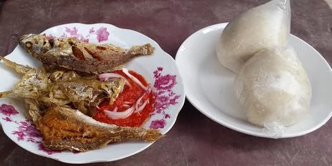 A plate of banku and fried fish and pepper a Ghana, West African food. Stock Photos