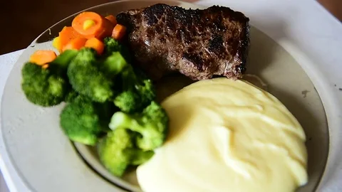 Plate with beef steak, mashed potatoes, carrots and broccoli Video stock 69205655
