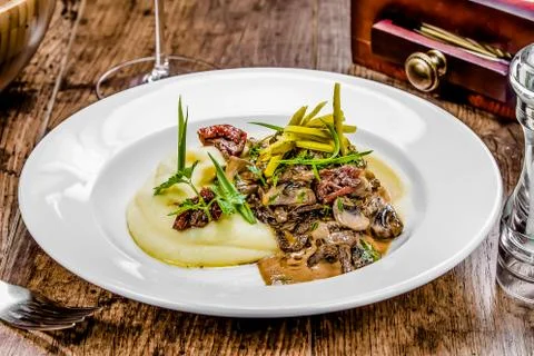 A plate of beef stroganoff on a table Stock Photos