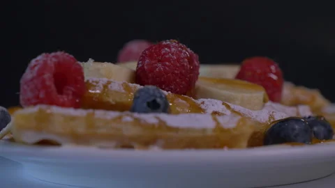Plate of Belgian Waffles, Maple Syrup. Banana Slices and Whipped Cream Video stock 130830656