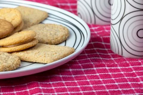 Plate of biscuits and cups on a red napkin Stock Photos
