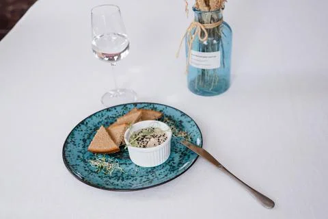 A plate with black bread and a bottle on the table in a restaurant Stock Photos