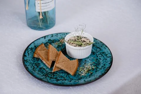 A plate with black bread and a bottle on the table in a restaurant Stock Photos