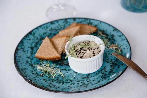 A plate with black bread and a bottle on the table in a restaurant Stock Photos