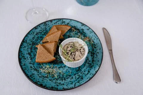 A plate with black bread and a bottle on the table in a restaurant Stock Photos