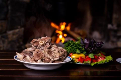 A plate of boiled meat, from which steam rises Stock Photos