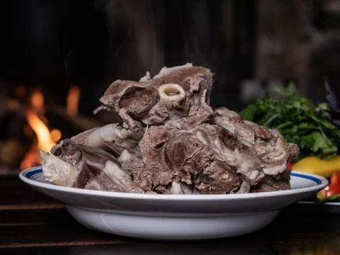 A plate of boiled meat, from which steam rises Stock Photos
