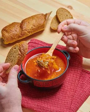 A plate of borscht and bread is on the table Stock Photos