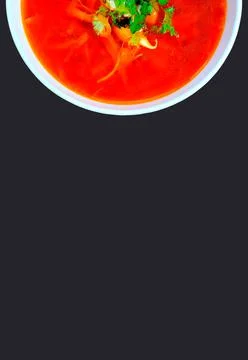 A plate of borscht on a black background. Beetroot soup. Traditional cuisine. Stock Photos