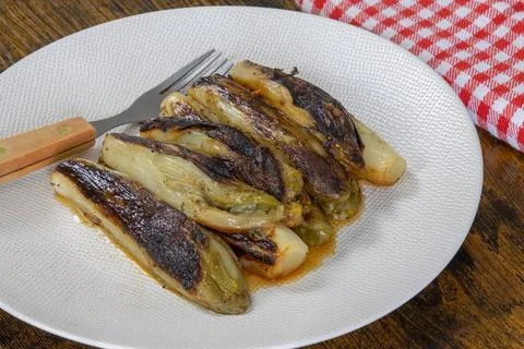 Plate of braised endives close-up on a table Stock Photos