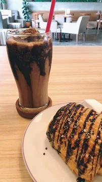 A plate of bread and a chocolate on a table Stock Photos