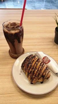 A plate of bread and a chocolate on a table Stock Photos