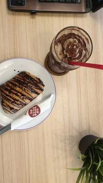A plate of bread and a chocolate on a table Stock Photos