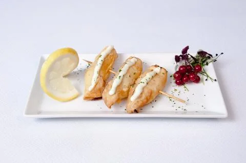 A plate of breaded fish on a white background Stock Photos