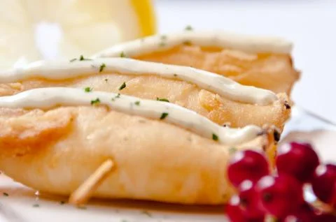 A plate of breaded fish on a white background Stock Photos