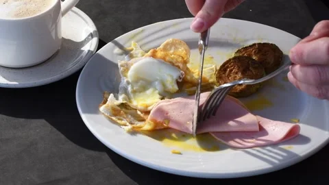 Plate with breakfast on table illuminated by morning sun, eggs, ham and zucchini Stock Footage 284178170