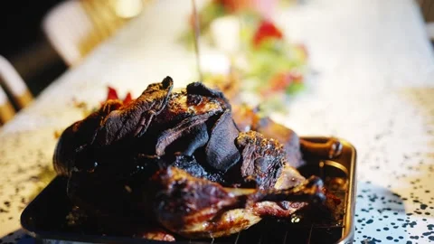 A plate of burnt meat sits on a table Stock Footage 295370570